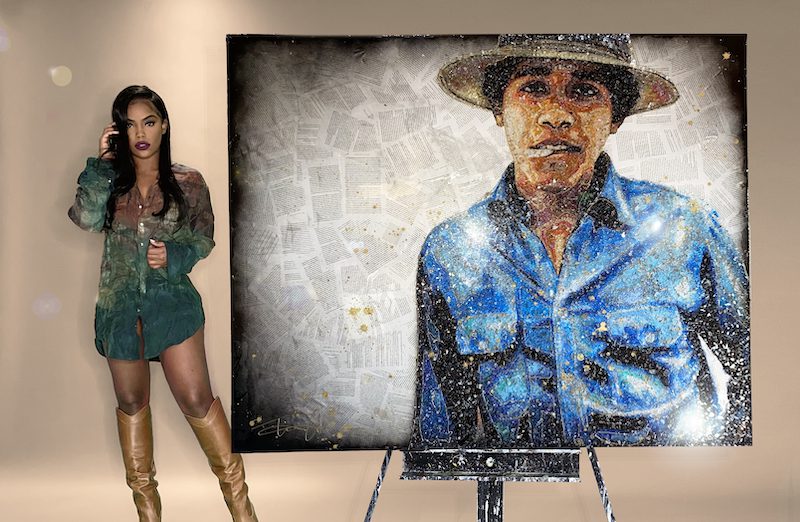 Tiffanie Anderson standing in front of her Barak Obama artwork