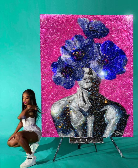 Tiffanie Anderson posing by her artwork